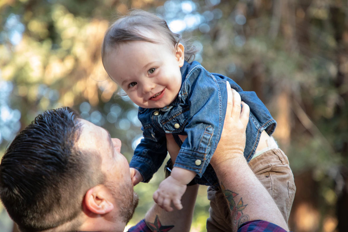 A father sharing a happy moment with his young child outdoors